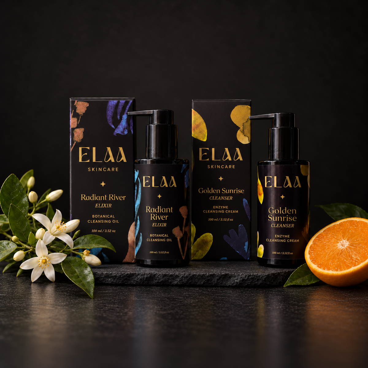 ELAA Cleansers collection arranged on dark slate with softly lit packaging
