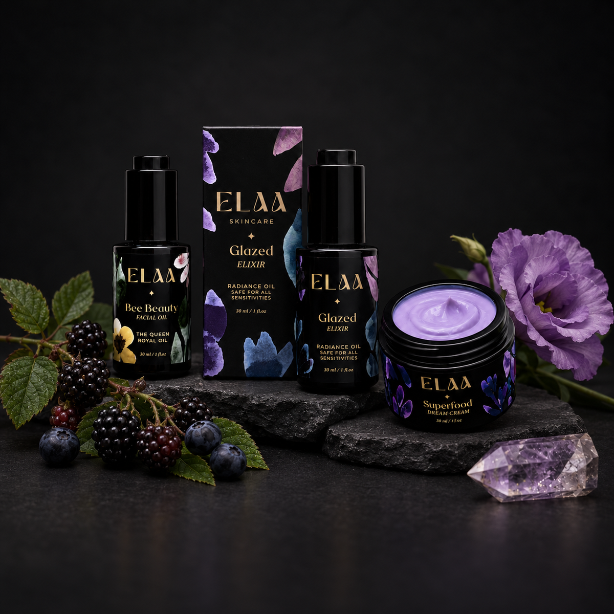 ELAA Moisturizers collection arranged on dark slate with softly lit packaging