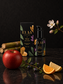 ELAA Glow AHA Dew with botanicals on a flat dark surface