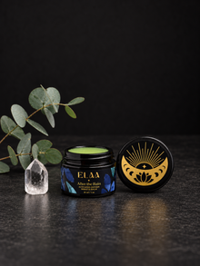 ELAA After The Rain jar with open green balm, eucalyptus and crystal on a flat dark surface