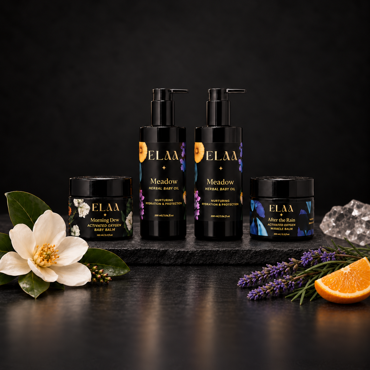 ELAA Baby Ritual product ritual arranged on dark slate with softly lit packaging