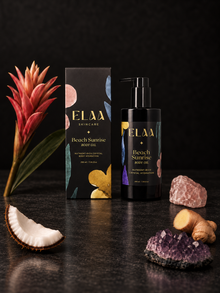 ELAA Beach Sunrise with botanicals on a flat dark surface