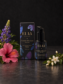 ELAA Cosmic Blossom Nectar bottle and carton with fresh hibiscus, lupine and white blossoms on dark stone