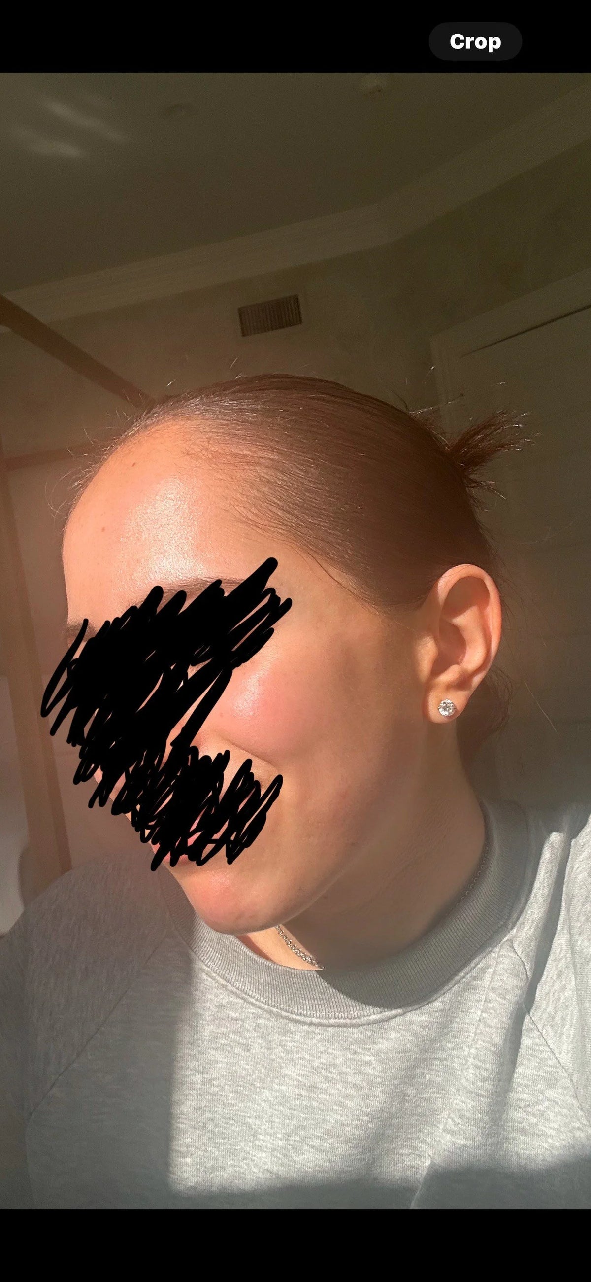 Close-up of a woman's face with her hair pulled back