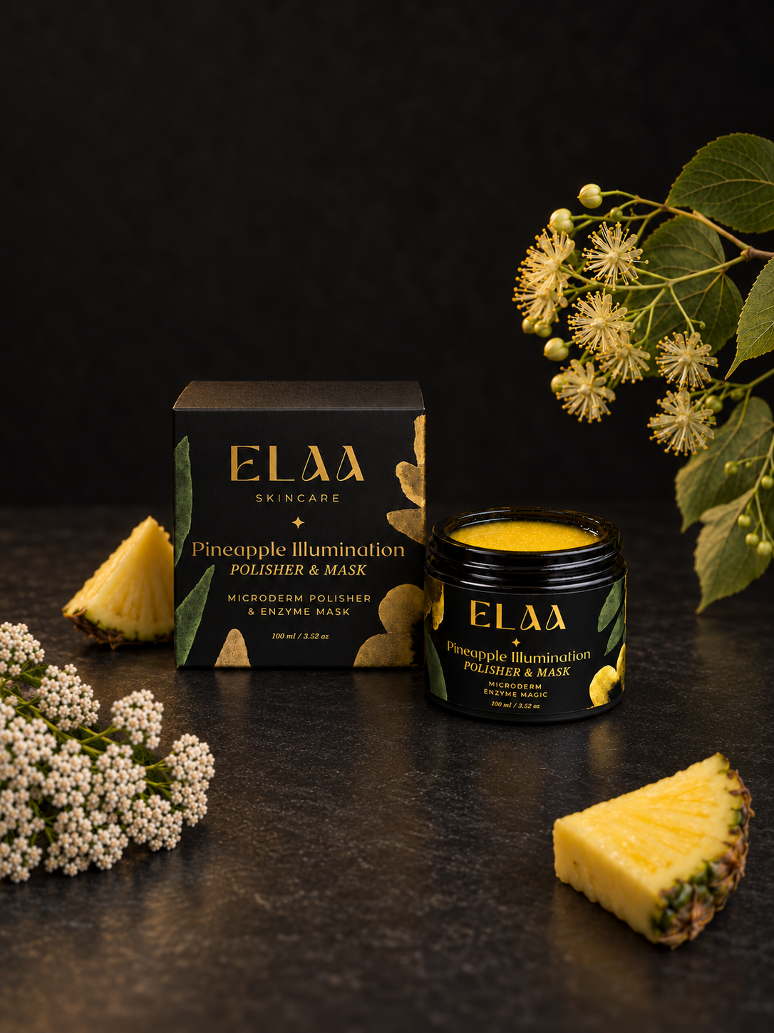 ELAA Pineapple Illumination polisher with carton, pineapple and flowers on a flat dark surface
