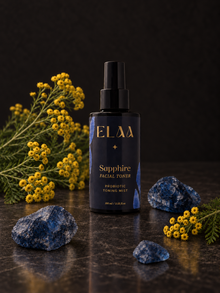 ELAA Sapphire Probiotic Toning Mist with yellow tansy and blue mineral specimens in soft light on dark stone