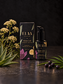 ELAA Stem Cell Firming Nectar bottle and carton with aloe, white blossoms, five acai berries and palm leaflets on dark stone